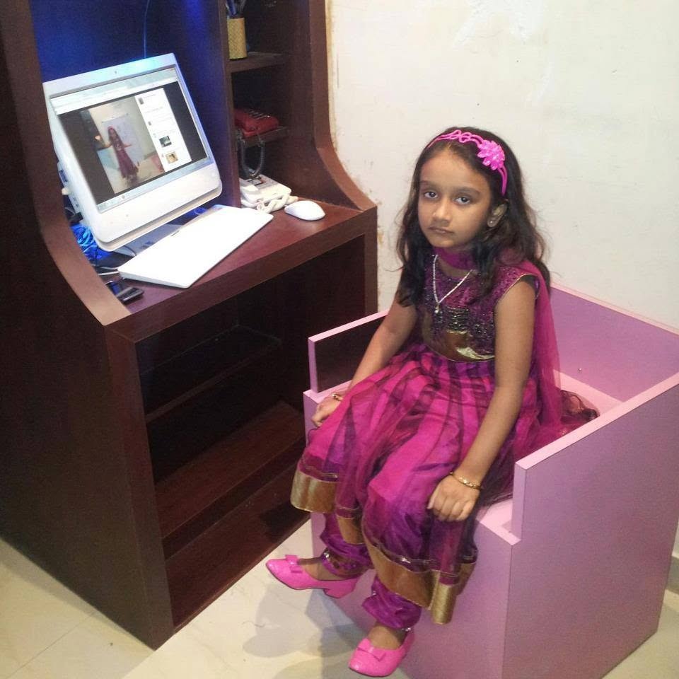 Veda in a magenta lehenga at her pink chair