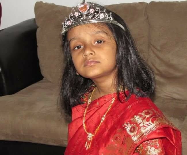 Veda in a red saree with a silver tiara
